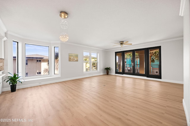 unfurnished living room with baseboards, wood finished floors, and ornamental molding