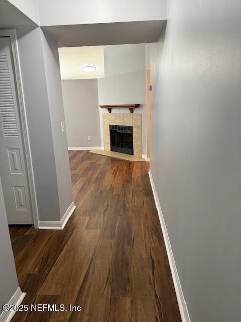 hallway featuring baseboards and wood finished floors