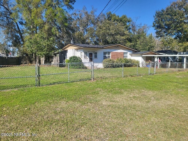 view of front of house with a front lawn, a gate, a fenced front yard, a carport, and brick siding