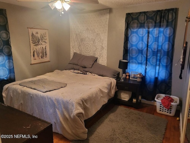 bedroom with ceiling fan and wood finished floors