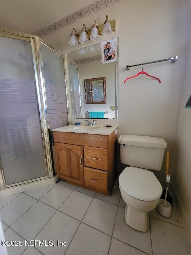 full bath featuring vanity, tile patterned floors, toilet, and a shower stall