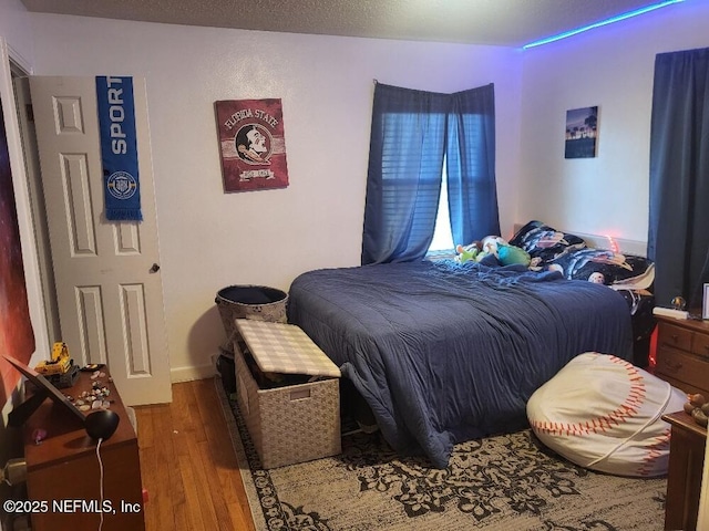 bedroom featuring wood finished floors