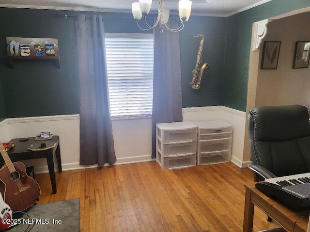 office featuring a notable chandelier, light wood-style flooring, crown molding, and baseboards