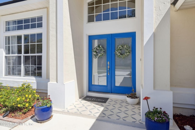 doorway to property with stucco siding and french doors