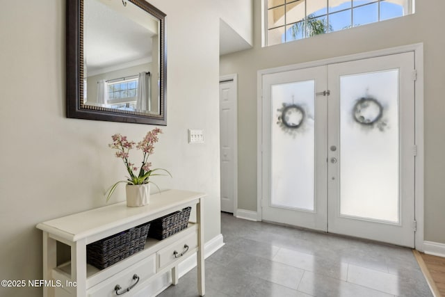 foyer entrance featuring french doors and baseboards