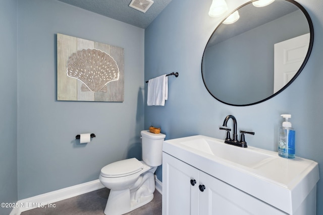 half bath featuring visible vents, baseboards, toilet, vanity, and a textured ceiling