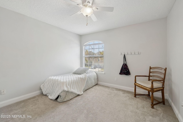 bedroom featuring carpet flooring, a textured ceiling, baseboards, and a ceiling fan