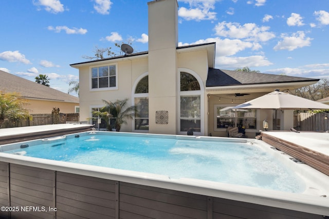 view of pool featuring a patio area, a pool, and fence