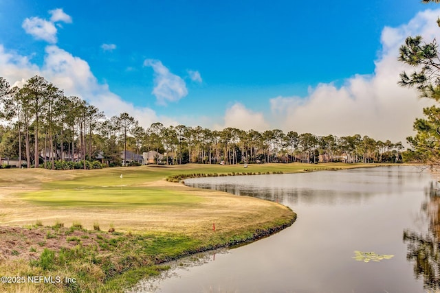 view of home's community featuring a lawn, view of golf course, and a water view