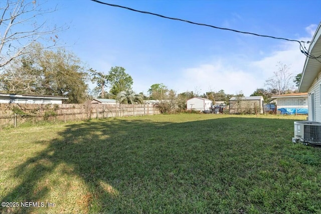 view of yard featuring cooling unit and fence