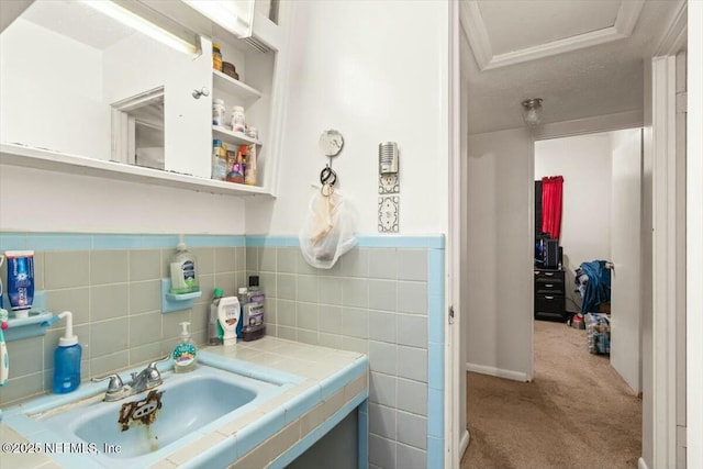 bathroom featuring wainscoting, vanity, and tile walls