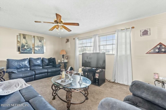 living area with light colored carpet, a textured ceiling, and a ceiling fan