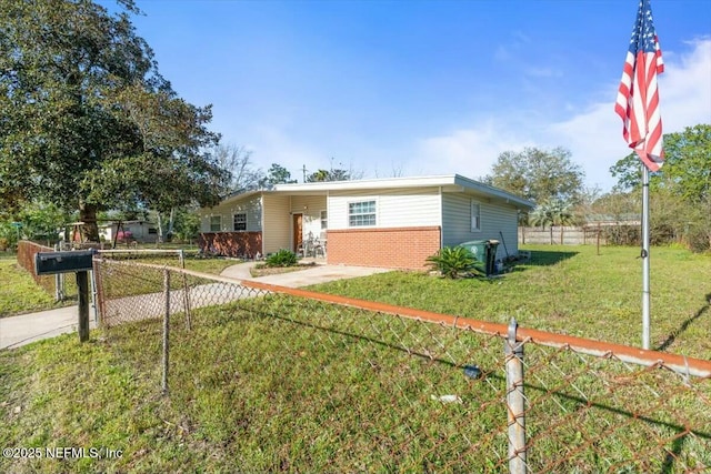 view of front of home featuring brick siding, a front yard, and fence