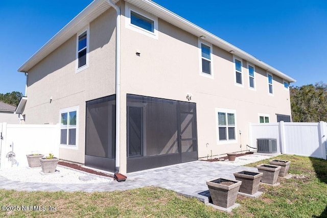 back of property featuring cooling unit, fence, a vegetable garden, stucco siding, and a patio area