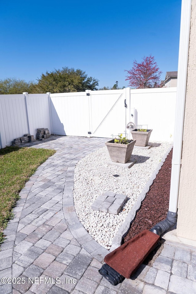 view of patio with a fenced backyard and a gate