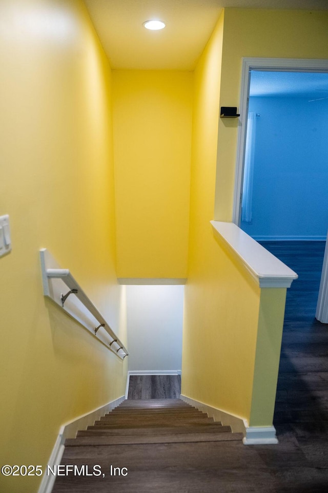 staircase featuring recessed lighting, baseboards, and wood finished floors