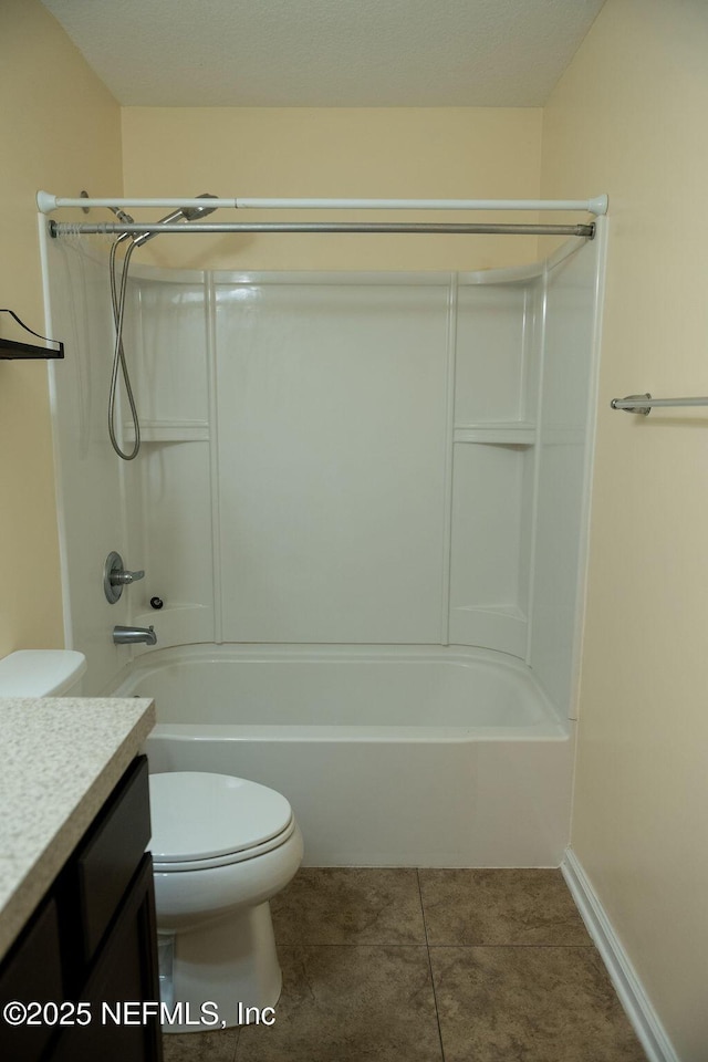 full bathroom featuring toilet, tile patterned flooring, baseboards, bathing tub / shower combination, and vanity