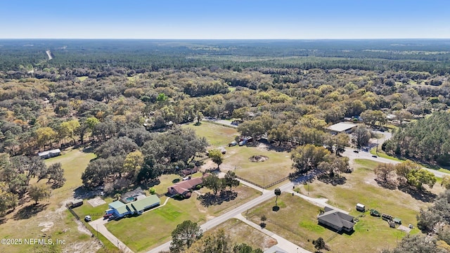 bird's eye view with a wooded view