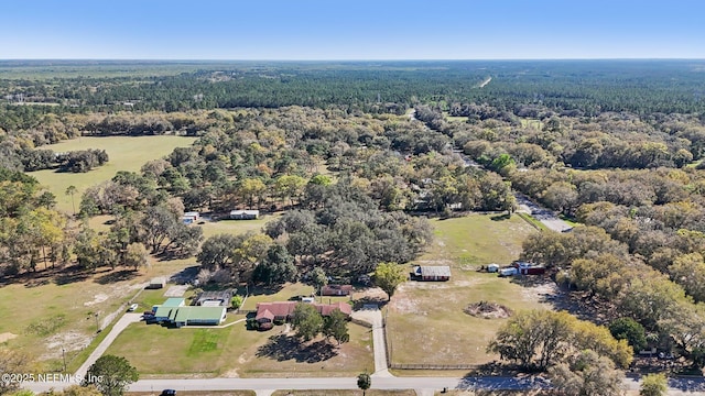 drone / aerial view featuring a forest view