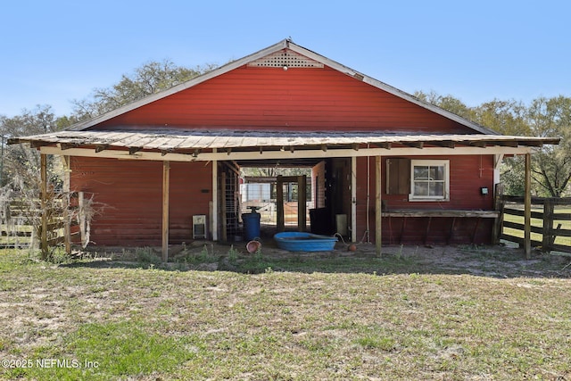 view of side of home with a yard and fence