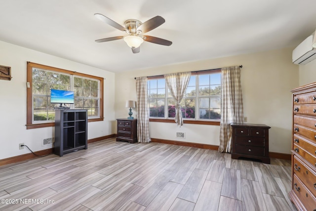 unfurnished bedroom with a wall mounted AC, ceiling fan, baseboards, and wood finish floors