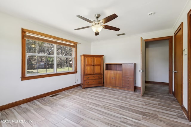 unfurnished bedroom featuring ceiling fan, baseboards, visible vents, and light wood-type flooring