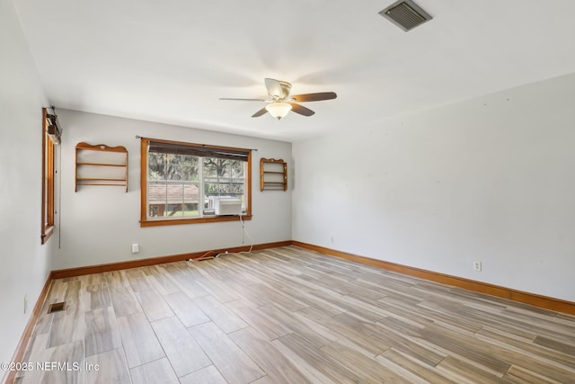 unfurnished room with light wood finished floors, visible vents, and ceiling fan