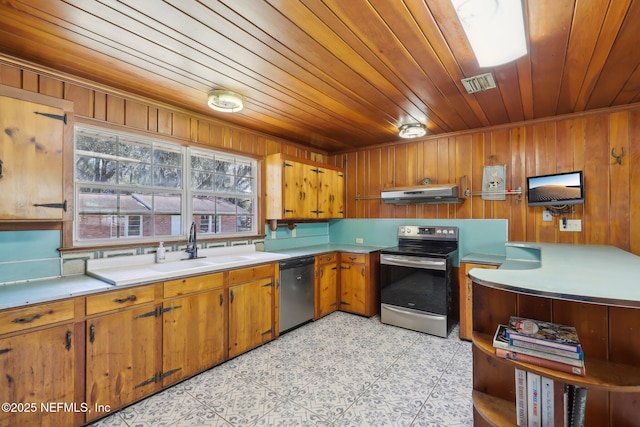 kitchen featuring visible vents, under cabinet range hood, stainless steel appliances, brown cabinetry, and light countertops