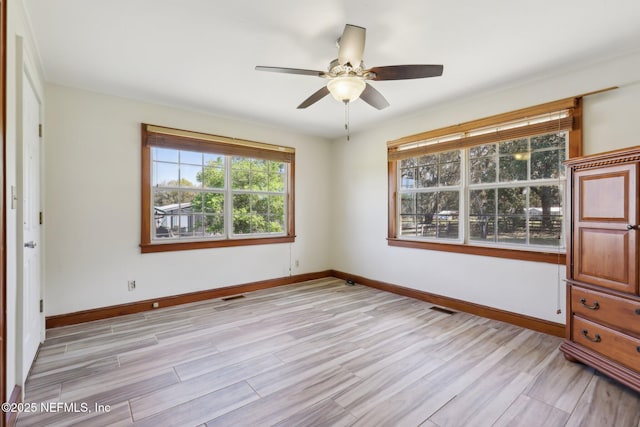 unfurnished bedroom featuring visible vents, light wood-style flooring, and baseboards