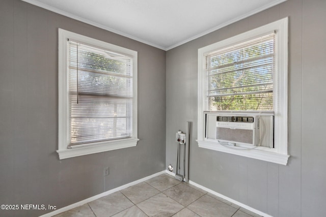 interior space featuring light tile patterned floors, baseboards, plenty of natural light, and crown molding