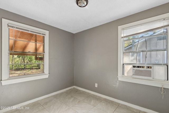 empty room featuring baseboards