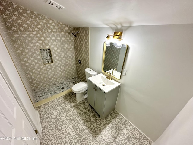 full bath with vanity, visible vents, tiled shower, tile patterned flooring, and toilet