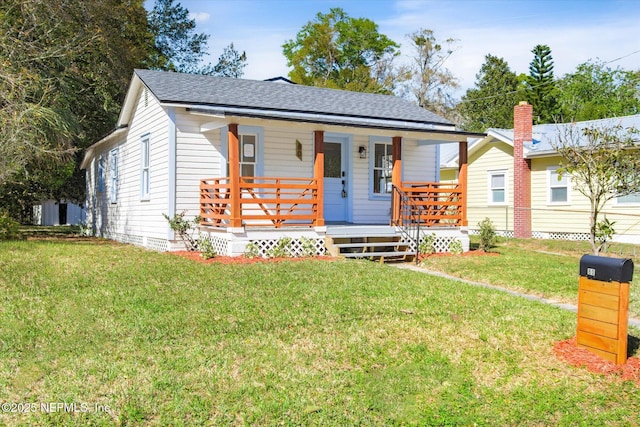 80 Anderson St, Saint Augustine, FL 32084 - view of front of house with a porch, a front lawn, and a shingled roof