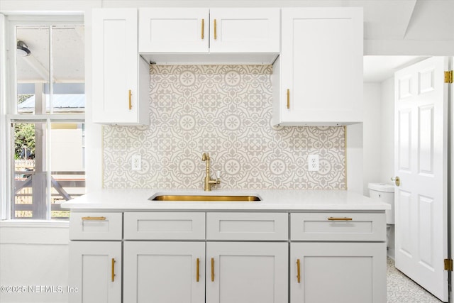 80 Anderson St, Saint Augustine, FL 32084 - kitchen with a sink, decorative backsplash, a wealth of natural light, and light countertops