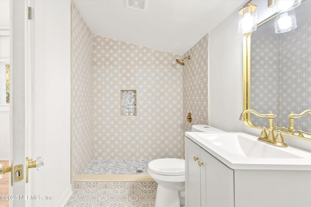 80 Anderson St, Saint Augustine, FL 32084 - full bath with vanity, visible vents, tiled shower, tile patterned flooring, and toilet