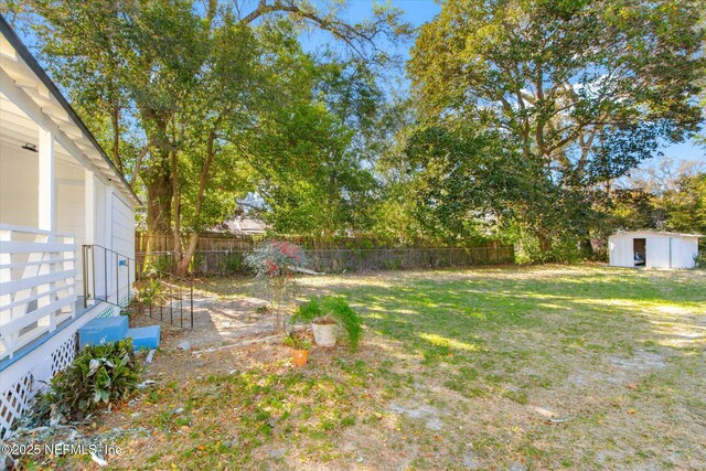 80 Anderson St, Saint Augustine, FL 32084 - view of yard featuring an outdoor structure, fence private yard, entry steps, and a shed