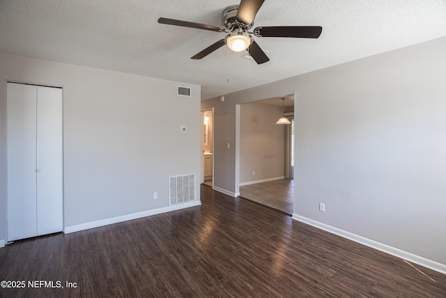 interior space featuring wood finished floors, visible vents, and a textured ceiling