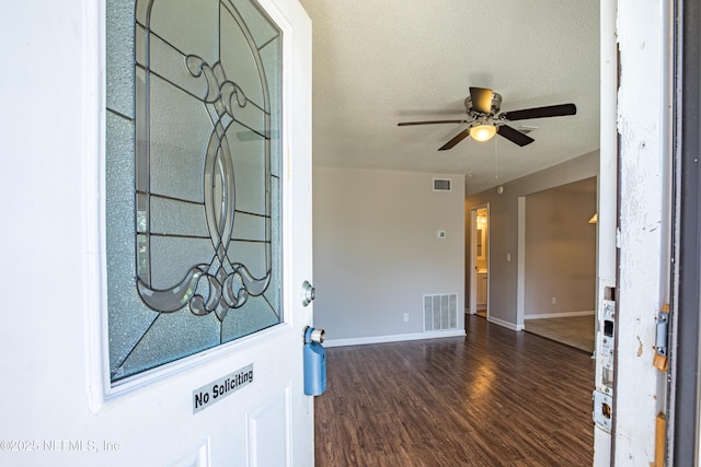 entrance foyer featuring visible vents, a ceiling fan, a textured ceiling, wood finished floors, and baseboards