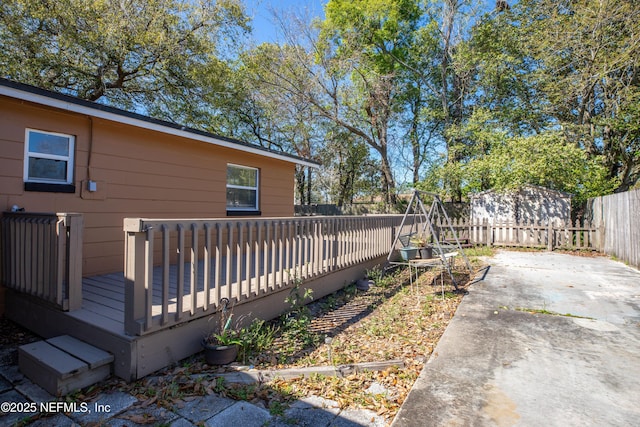 view of yard with a deck, a patio area, and a fenced backyard