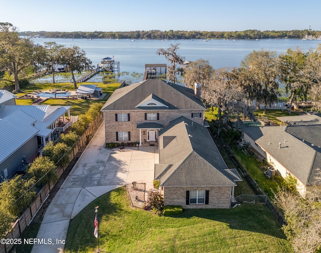 birds eye view of property with a water view