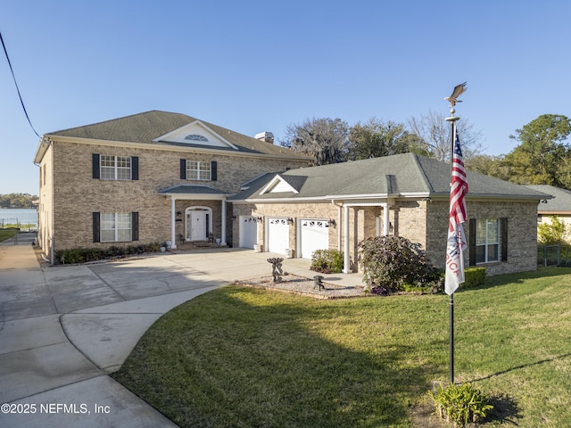 view of front of property featuring brick siding, a front lawn, concrete driveway, roof with shingles, and a garage