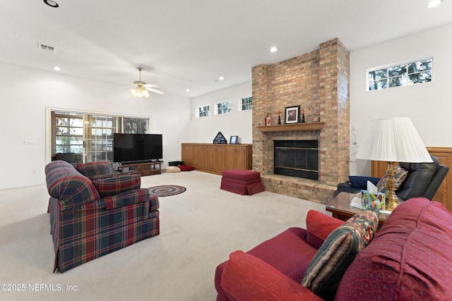 living room with a wealth of natural light, carpet floors, a brick fireplace, and recessed lighting