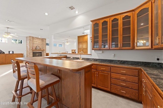 kitchen with dark countertops, visible vents, and ceiling fan