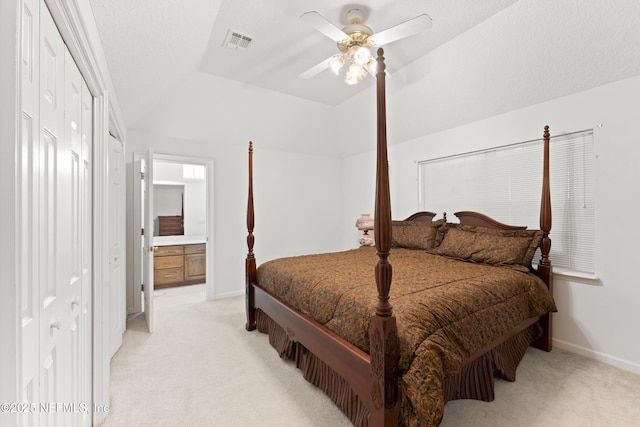 bedroom featuring light carpet, visible vents, and lofted ceiling