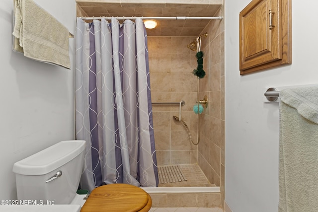 bathroom with toilet and a stall shower