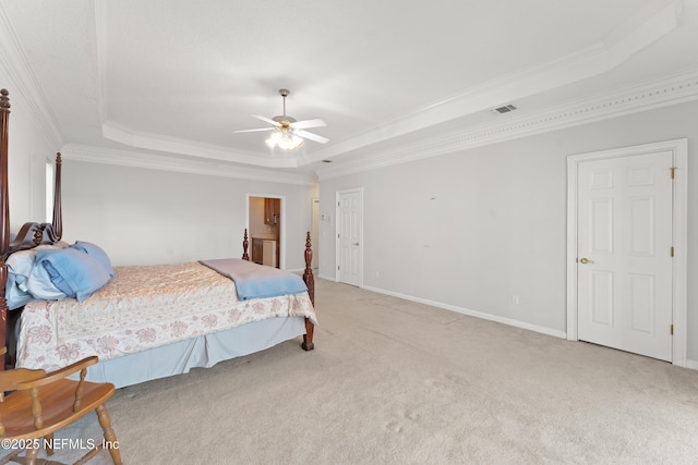 carpeted bedroom featuring a tray ceiling, baseboards, visible vents, and ornamental molding