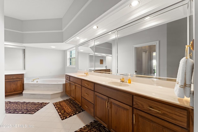 full bath featuring tile patterned flooring, double vanity, a bath, and a sink