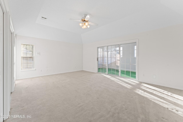 empty room with light carpet, visible vents, a healthy amount of sunlight, and a ceiling fan