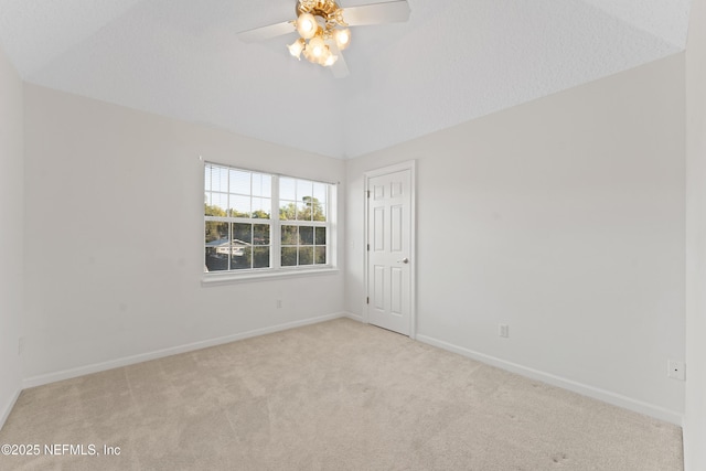 empty room featuring baseboards, lofted ceiling, carpet, and ceiling fan