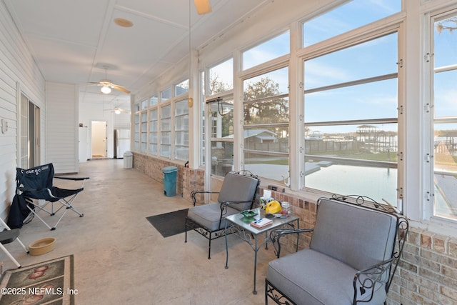 sunroom / solarium featuring ceiling fan